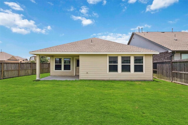 2539 Blazing Star Dr, Brookshire, TX 77423 - rear view of property featuring a patio area, a fenced backyard, and a shingled roof