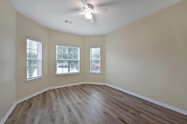 19823 White Pearl Ct, Houston, TX 77073 - unfurnished room with healthy amount of natural light, wood finished floors, and a ceiling fan