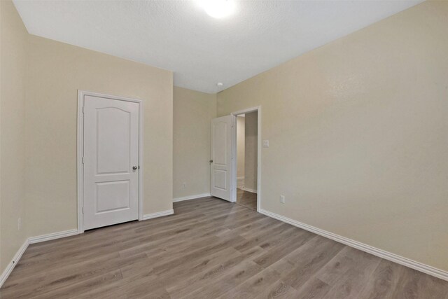 19823 White Pearl Ct, Houston, TX 77073 - unfurnished bedroom featuring wood finished floors and baseboards