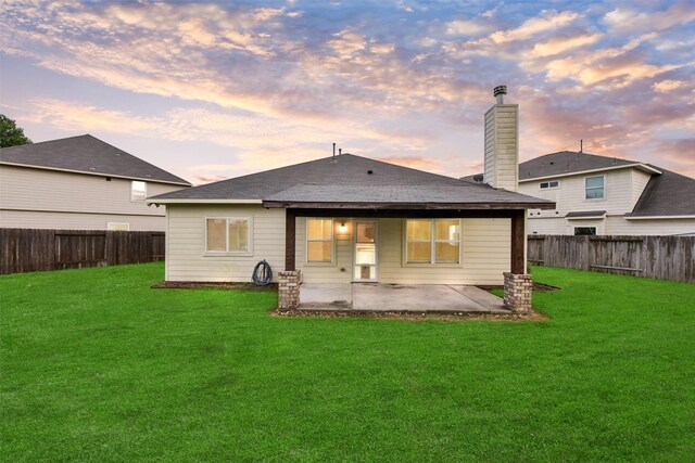 19823 White Pearl Ct, Houston, TX 77073 - back of house at dusk with a patio, a fenced backyard, a chimney, and a shingled roof
