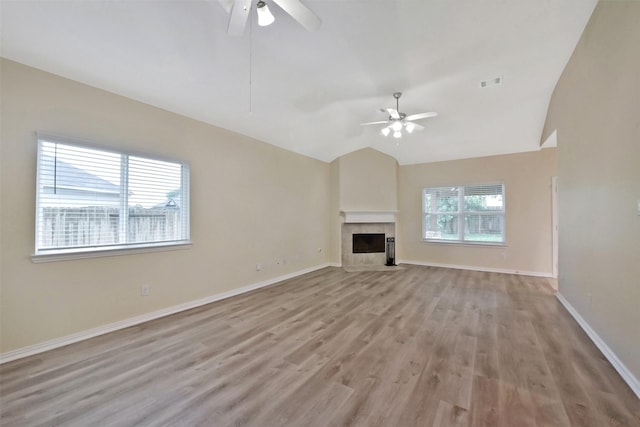 19823 White Pearl Ct, Houston, TX 77073 - unfurnished living room with a ceiling fan, light wood-style flooring, lofted ceiling, and a fireplace