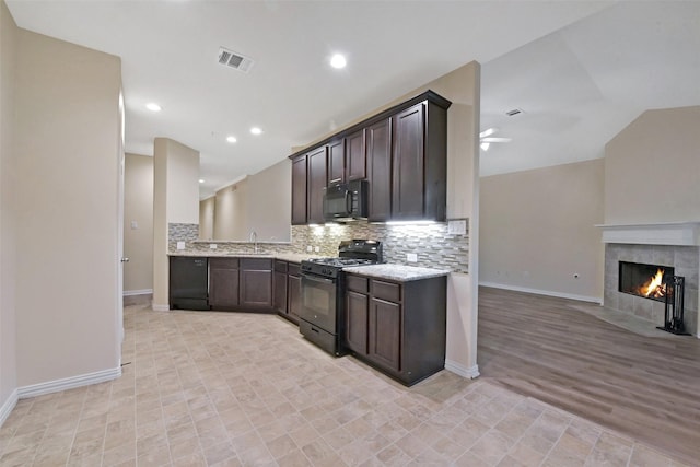 19823 White Pearl Ct, Houston, TX 77073 - kitchen with black appliances, open floor plan, dark brown cabinetry, decorative backsplash, and a ceiling fan