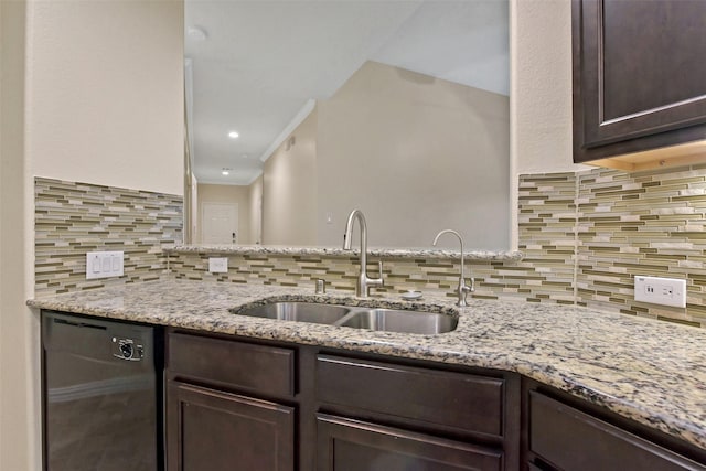 19823 White Pearl Ct, Houston, TX 77073 - kitchen with dishwashing machine, dark brown cabinets, tasteful backsplash, and light stone countertops