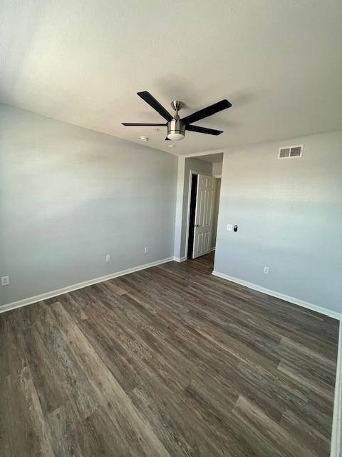 7575 Kirby Dr Unit 2314, Houston, TX 77030 - empty room with a ceiling fan and dark wood-type flooring