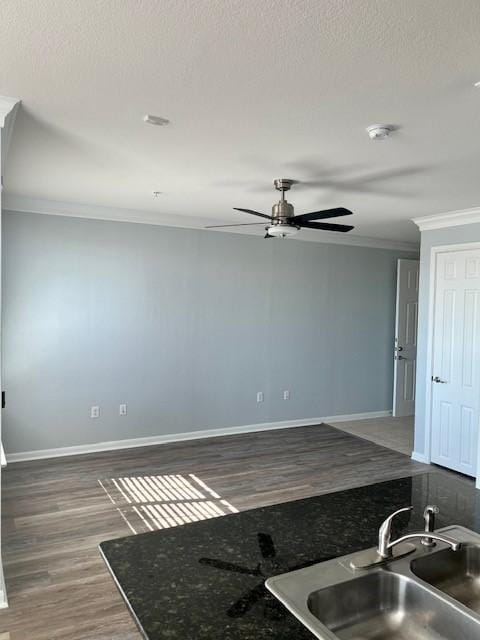 7575 Kirby Dr Unit 2314, Houston, TX 77030 - kitchen featuring crown molding, ceiling fan, wood finished floors, a textured ceiling, and dark countertops