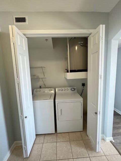 7575 Kirby Dr Unit 2314, Houston, TX 77030 - laundry room featuring washer and dryer and light tile patterned floors
