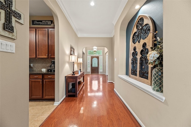 20811 S Amber Willow Trl, Cypress, TX 77433 - entrance foyer with arched walkways, light wood finished floors, and ornamental molding