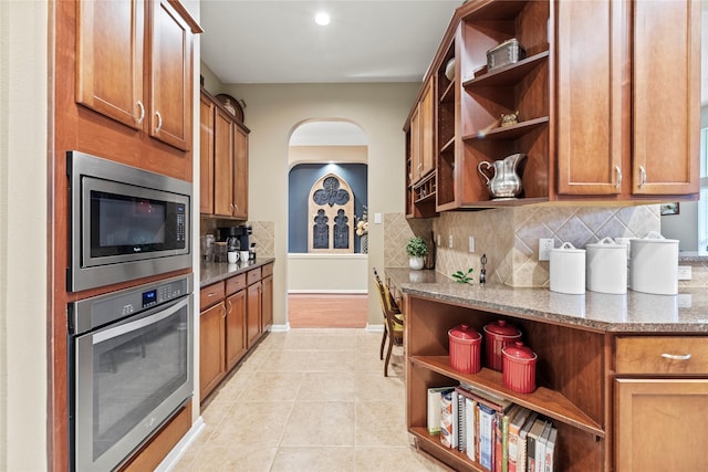 20811 S Amber Willow Trl, Cypress, TX 77433 - kitchen featuring open shelves, stainless steel appliances, backsplash, and dark stone counters