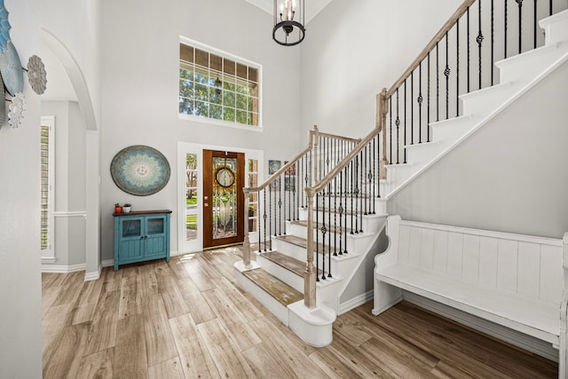 3506 Stanbury Place Ln, Katy, TX 77494 - entrance foyer featuring wood finished floors, a towering ceiling, stairway, and arched walkways