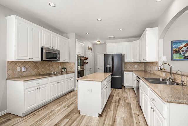 3506 Stanbury Place Ln, Katy, TX 77494 - kitchen with stainless steel appliances, light wood-style floors, white cabinets, recessed lighting, and backsplash