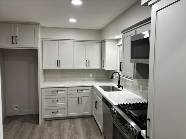 3706 Galway Ln, Houston, TX 77080 - kitchen with stainless steel appliances, light stone counters, tasteful backsplash, dark wood-style flooring, and recessed lighting