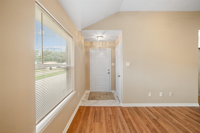 5532 N Buffalo Cir, Willis, TX 77378 - foyer with light wood finished floors and vaulted ceiling
