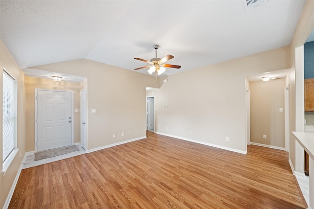 5532 N Buffalo Cir, Willis, TX 77378 - unfurnished living room with light wood-style flooring, a ceiling fan, and vaulted ceiling