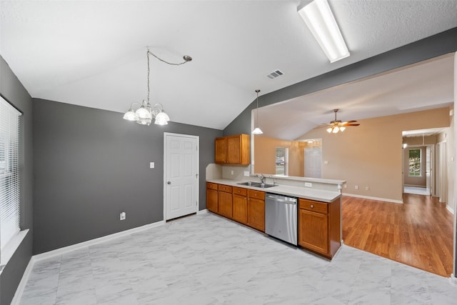 5532 N Buffalo Cir, Willis, TX 77378 - kitchen with stainless steel dishwasher, a peninsula, brown cabinetry, light marble finish floors, and vaulted ceiling