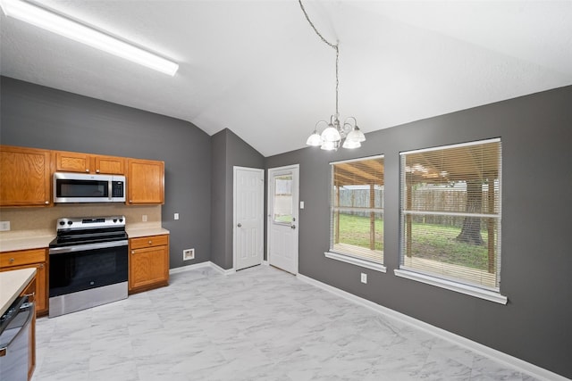 5532 N Buffalo Cir, Willis, TX 77378 - kitchen with appliances with stainless steel finishes, vaulted ceiling, a chandelier, light countertops, and pendant lighting
