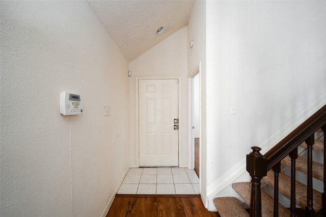 2300 Old Spanish Trl Unit 2063, Houston, TX 77054 - entrance foyer featuring vaulted ceiling, a textured ceiling, wood finished floors, and stairway