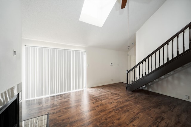 2300 Old Spanish Trl Unit 2063, Houston, TX 77054 - unfurnished living room featuring stairway, ceiling fan, wood finished floors, high vaulted ceiling, and a skylight
