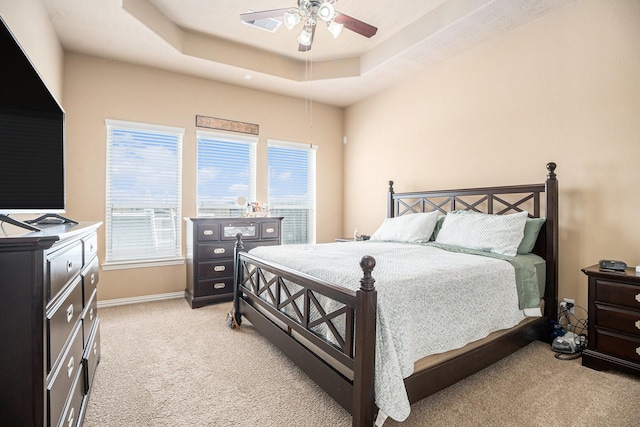 3018 Cambridge Meadows Ln, Dickinson, TX 77539 - bedroom featuring light carpet, multiple windows, and a raised ceiling