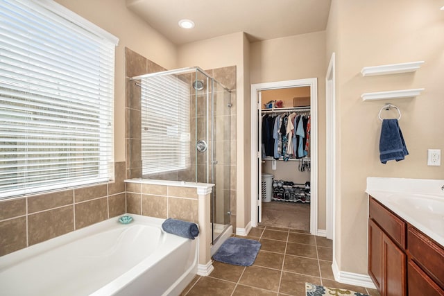3018 Cambridge Meadows Ln, Dickinson, TX 77539 - full bath with a stall shower, a garden tub, a walk in closet, vanity, and tile patterned flooring