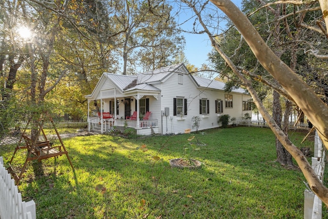 91 Willow St, Point Blank, TX 77364 - view of front of house with covered porch, a fenced backyard, and a metal roof