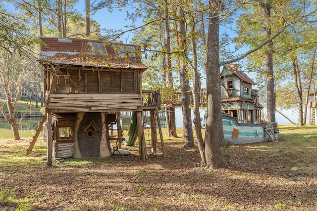 91 Willow St, Point Blank, TX 77364 - view of outdoor structure featuring a sunroom and a water view