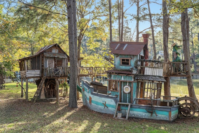 91 Willow St, Point Blank, TX 77364 - rear view of house with a chimney, a playground, and a water view