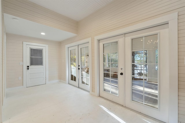 91 Willow St, Point Blank, TX 77364 - doorway to outside with french doors, wooden walls, and concrete floors
