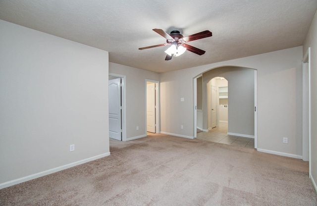 1814 High Falls Ln, Pearland, TX 77581 - unfurnished bedroom featuring arched walkways, light colored carpet, ceiling fan, and a textured ceiling