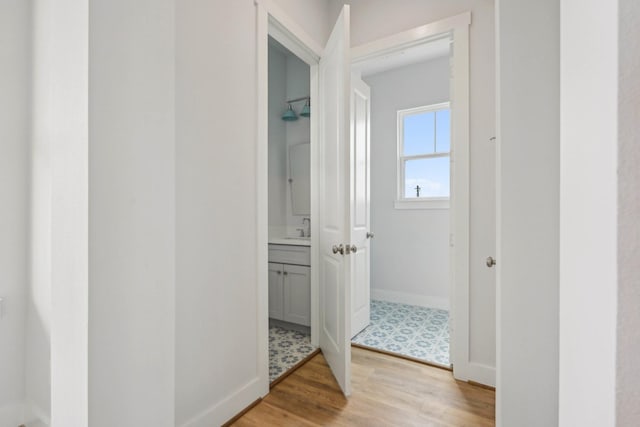 26726 Estuary Dr, Galveston, TX 77554 - hall featuring light wood-style flooring and a sink
