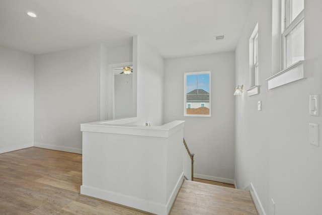 26726 Estuary Dr, Galveston, TX 77554 - hallway with light wood finished floors and an upstairs landing