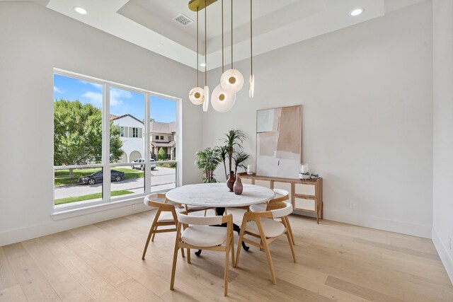 5200 Mimosa Dr, Bellaire, TX 77401 - dining room featuring light wood-type flooring, recessed lighting, a tray ceiling, and a towering ceiling
