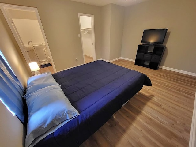 211 Peach St, Sweeny, TX 77480 - bedroom with light wood finished floors and a spacious closet