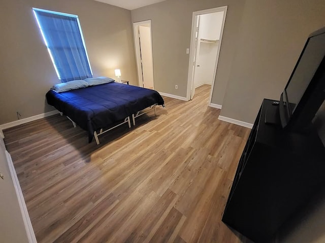 211 Peach St, Sweeny, TX 77480 - bedroom with wood finished floors and a spacious closet