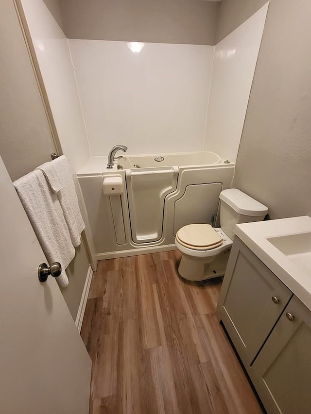 211 Peach St, Sweeny, TX 77480 - full bathroom featuring vanity, a bath, and wood finished floors