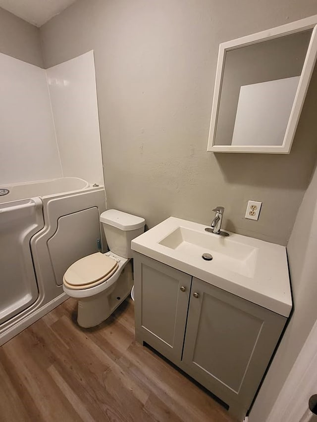 211 Peach St, Sweeny, TX 77480 - bathroom with wood finished floors, vanity, and a bath
