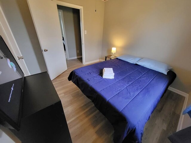 211 Peach St, Sweeny, TX 77480 - bedroom featuring wood finished floors