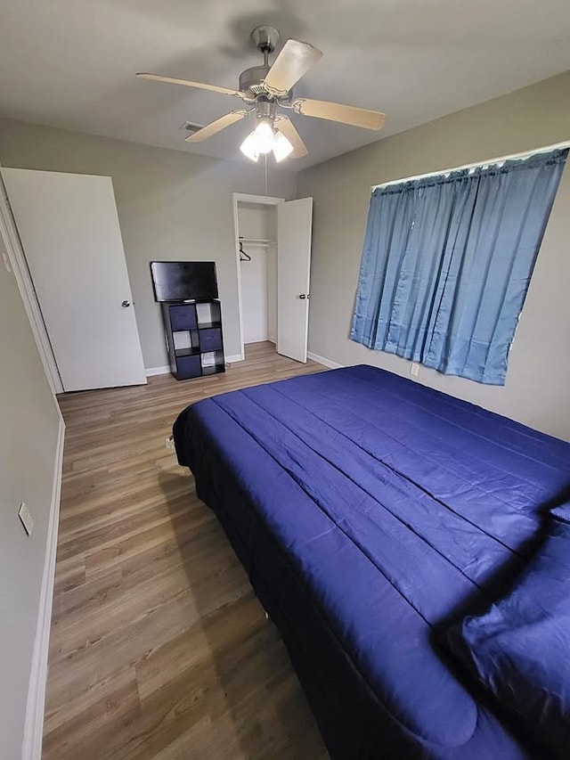 211 Peach St, Sweeny, TX 77480 - bedroom with wood finished floors, ceiling fan, and a closet