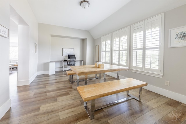 27706 Lakeway Trail Ln, Fulshear, TX 77441 - dining room featuring a desk, light wood finished floors, and vaulted ceiling