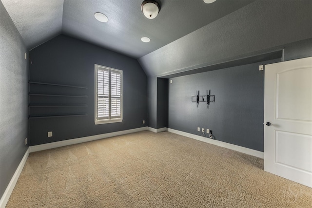 27706 Lakeway Trail Ln, Fulshear, TX 77441 - additional living space with vaulted ceiling, carpet, and a textured ceiling