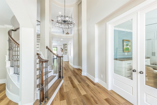 27706 Lakeway Trail Ln, Fulshear, TX 77441 - entrance foyer featuring light wood-style flooring, stairs, and a chandelier
