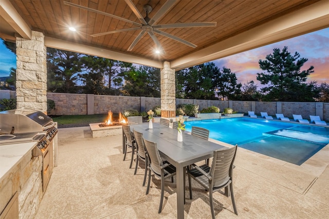 27706 Lakeway Trail Ln, Fulshear, TX 77441 - view of pool featuring an outdoor fire pit, a patio, an outdoor kitchen, a fenced backyard, and outdoor dining space