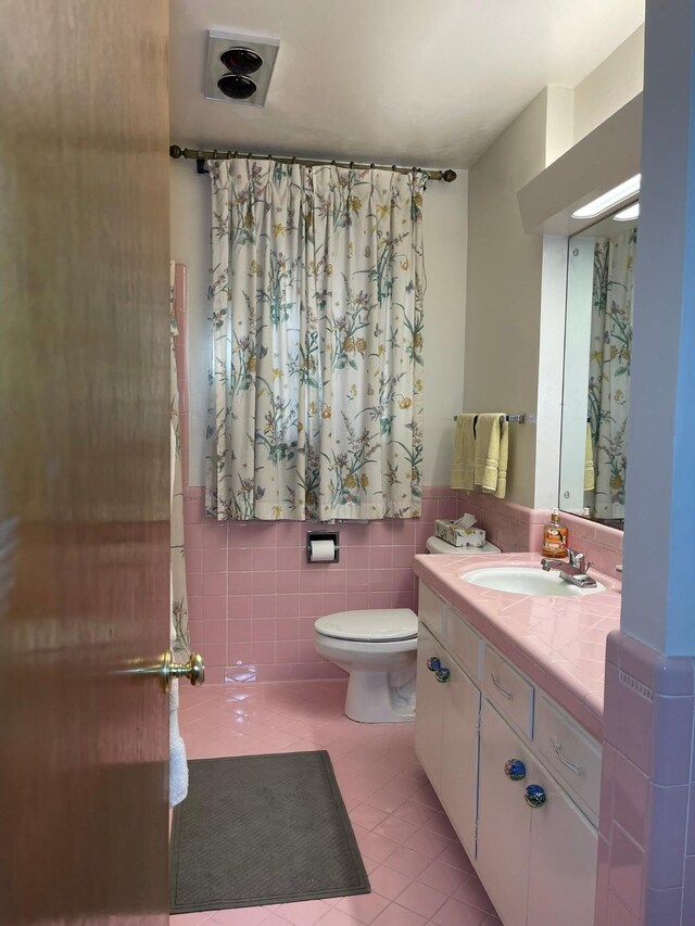 3102 Satellite Dr, San Antonio, TX 78217 - bathroom with vanity, tile walls, tile patterned floors, and wainscoting