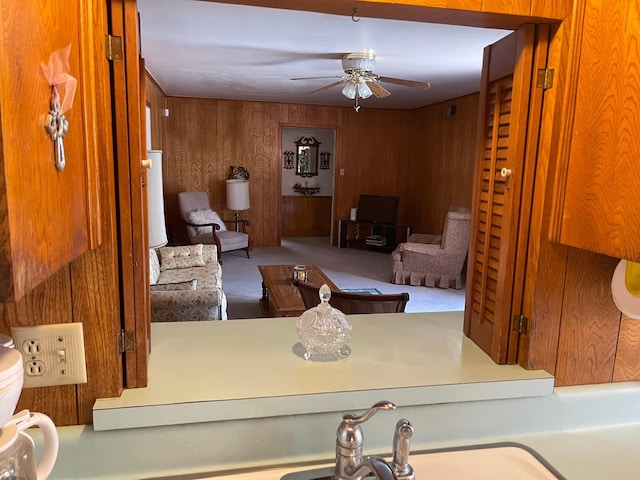 3102 Satellite Dr, San Antonio, TX 78217 - carpeted living room featuring a ceiling fan and wooden walls