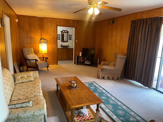 3102 Satellite Dr, San Antonio, TX 78217 - living area featuring carpet floors, wooden walls, and ceiling fan