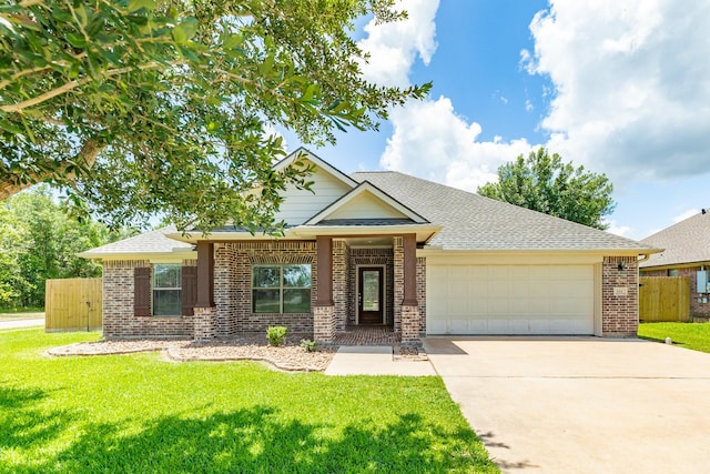 101 Brazos Ct, Richwood, TX 77531 - view of front of home featuring an attached garage, brick siding, concrete driveway, and a shingled roof