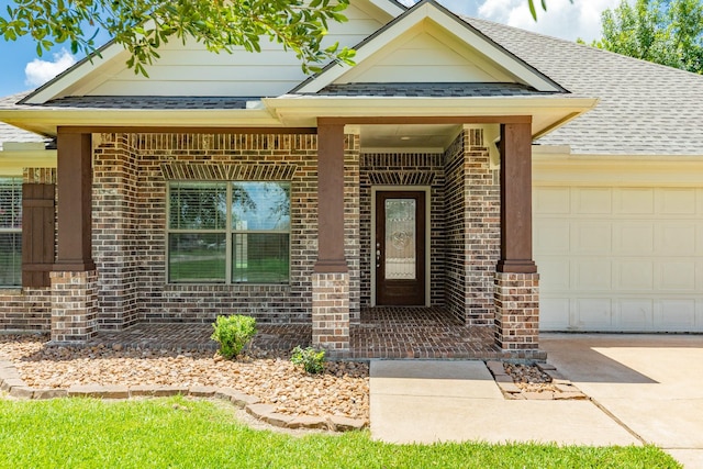 101 Brazos Ct, Richwood, TX 77531 - property entrance featuring brick siding, an attached garage, roof with shingles, and concrete driveway