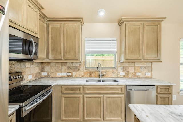 101 Brazos Ct, Richwood, TX 77531 - kitchen with stainless steel appliances, light brown cabinets, decorative backsplash, and light stone counters