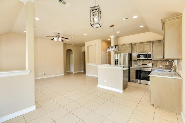 101 Brazos Ct, Richwood, TX 77531 - kitchen featuring stainless steel appliances, vaulted ceiling, light tile patterned floors, tasteful backsplash, and open floor plan
