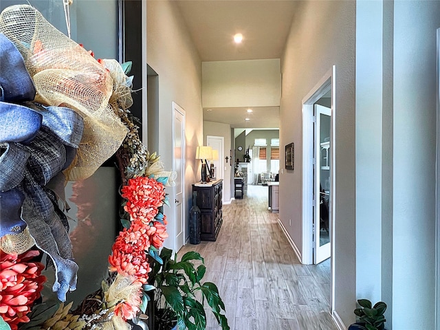 2 Ruchill Cir, Conroe, TX 77304 - hall with light wood-style floors, a high ceiling, and recessed lighting