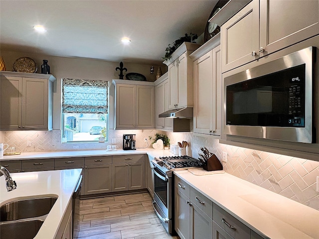 2 Ruchill Cir, Conroe, TX 77304 - kitchen featuring stainless steel appliances, gray cabinetry, tasteful backsplash, and recessed lighting
